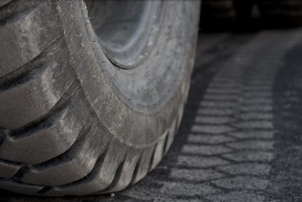close up of truck wheel and tirebprint on asphalt