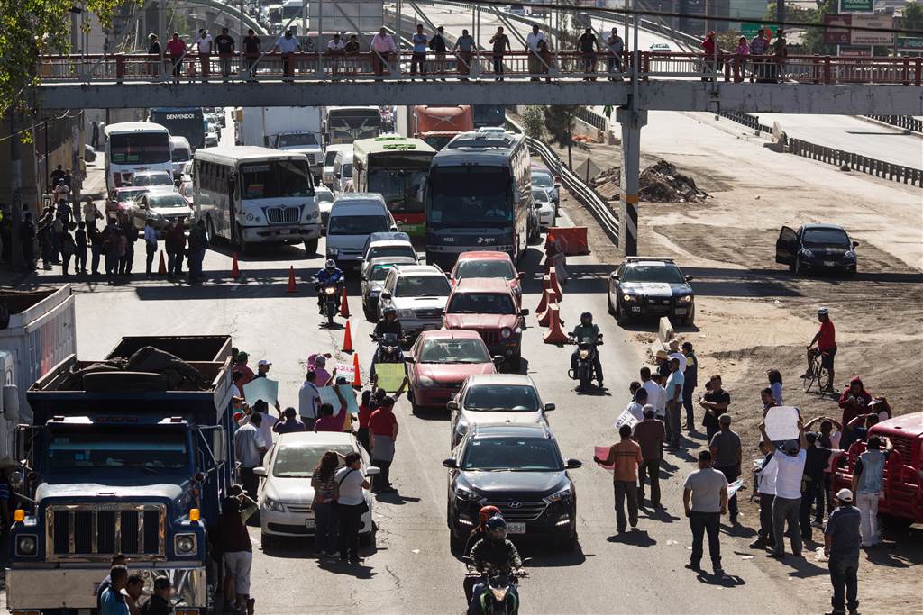 People block a highway leaving Mexico City as a protest to an increase in gas prices on Jan. 4. Photo Source: Brett Gundlock / Getty Images